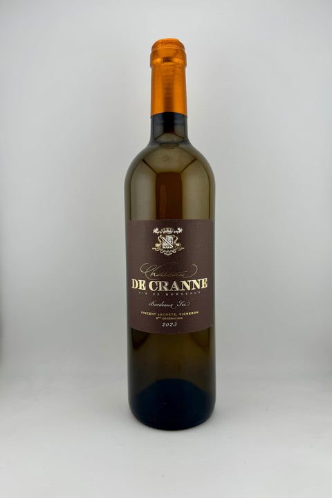 A bottle of white wine labeled 'De Cranne' with a yellow straw color depiction and notes of candied apricot and exotic fruit.