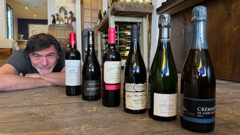 man on the floor with his Seasonal pics of wine