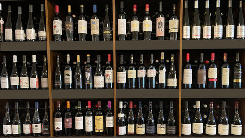 Wooden shelves filled with wine bottles
