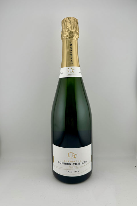 A bottle of Dourdon Vieillard Champagne with a golden foil top and a black label.