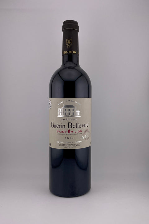 A bottle of Chateau Guerin Bellevue wine from St Emilion, 2019 vintage, predominantly dark with a label in the center.