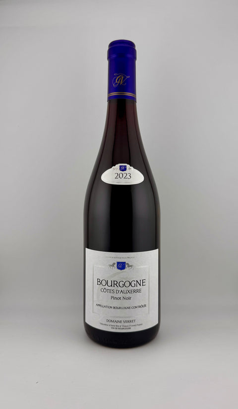 Bottle of Bourgogne wine, pinot noir 2023, with a purple label on a gray background
