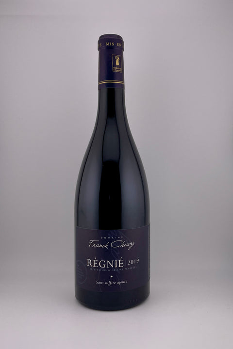 A bottle of Franck Chavy Regnié red wine with a label that includes the brand name and the type of wine.