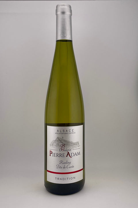 A bottle of Domaine Pierre Adam Riesling Tradition wine from Alsace, 2023, white wine.