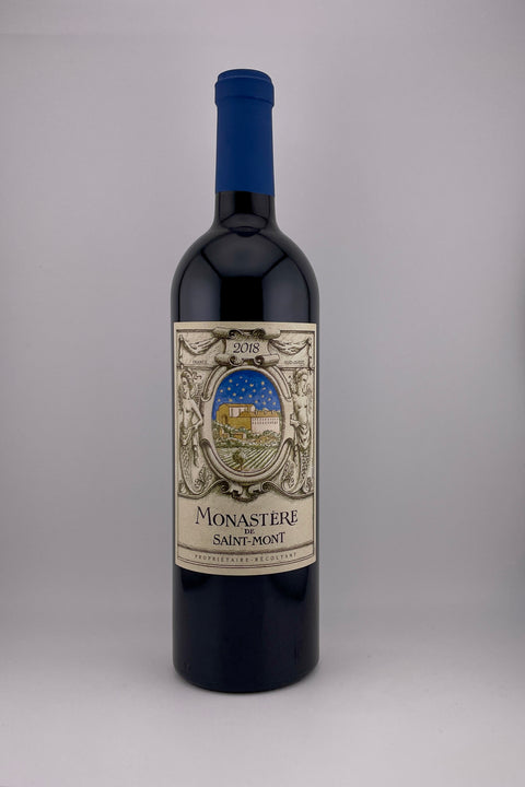 A bottle of Monastère Cave Plaimont red wine with a label depicting a vineyard scene and the year 2018.