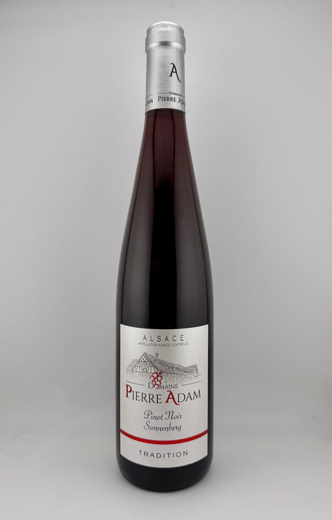 A bottle of Domaine Pierre Adam Pinot Noir wine from Alsace, 2022 vintage, with a dark label.