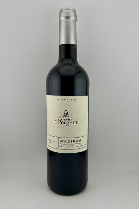 A bottle of Domaine Sergent Madiran wine with a dark label and a beige band indicating the brand and vintage, red wine