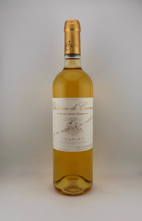 Bottle of Cuvée Annie Durras wine with a golden color and clear copper highlights, from Loupiac, Châte de Cranne, Bordeaux.